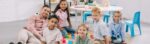 smiling-teacher-and-multicultural-preschoolers-sit-2023-11-27-05-19-51-utc-scaled-r3vems4lvwse854sn6aiuyiggc0x1x6gh21rzbco7w